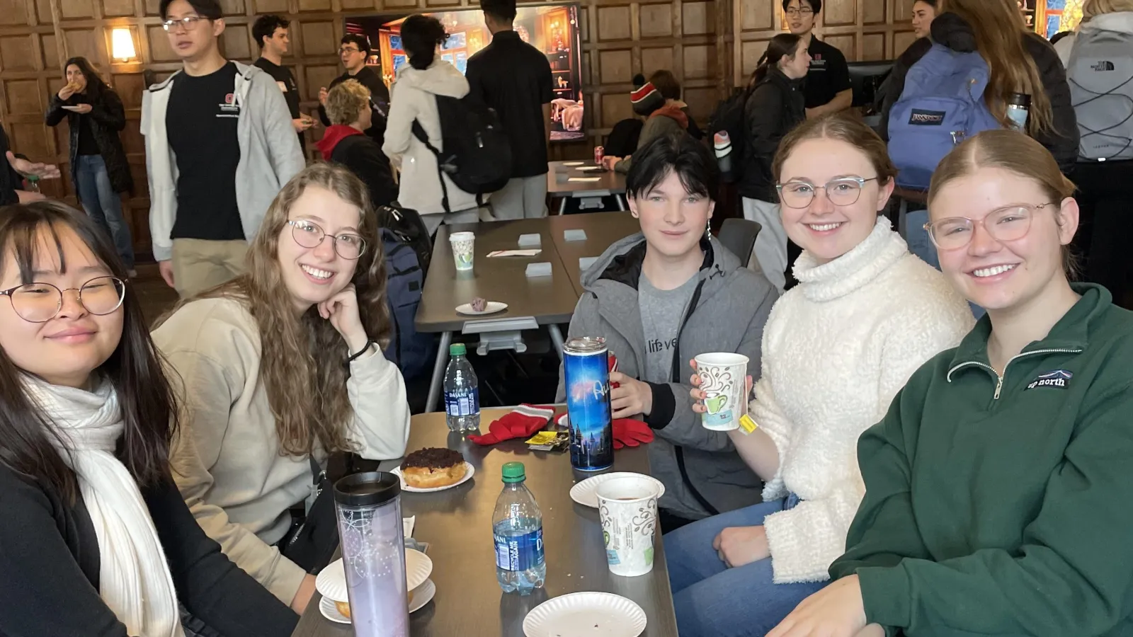 People sitting around a table smiling