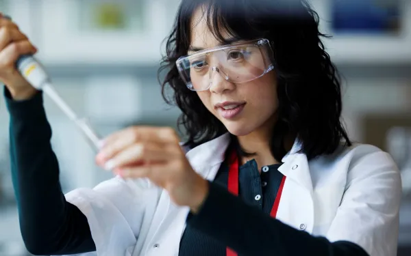 Researcher Holding a Pipet